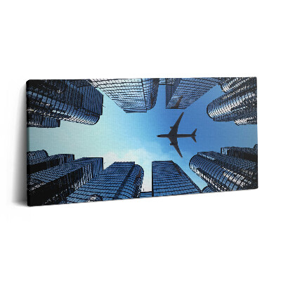 Vászonkép 140x70 Repülőgép az épületek felett