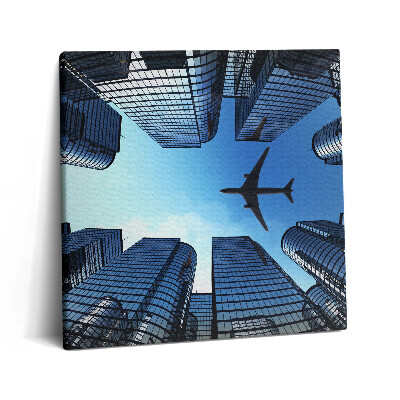 Vászonkép 60x60 Repülőgép az épületek felett