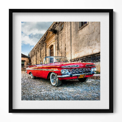 Keretezett falikép Piros klasszikus autó egy régi épület előtt