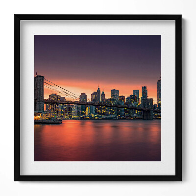 Keretezett falikép Híd és város skyline naplementében