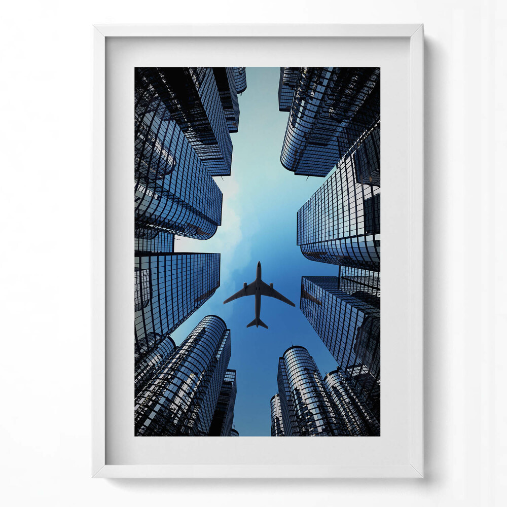 Függőleges kép keretben Repülőgép városi felhőkarcolók között